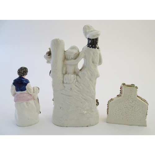 72 - Three items of Staffordshire pottery, to include a figural bud vase, a flatback house and a figure w... 