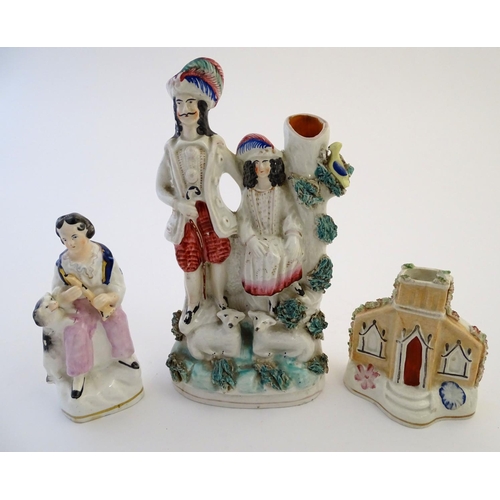 72 - Three items of Staffordshire pottery, to include a figural bud vase, a flatback house and a figure w... 