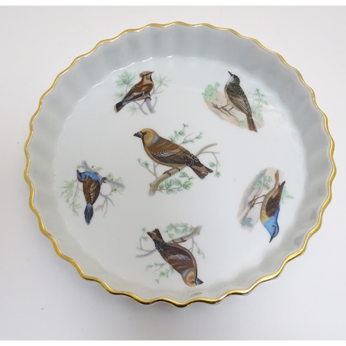 130 - A French L Lourioux Le Faune pie dish with fluted sides and gilt rim, decorated with six birds to in... 