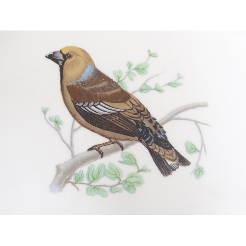 131 - A French L Lourioux Le Faune plate with a gilt rim decorated with a hawfinch bird on a branch. Marke... 