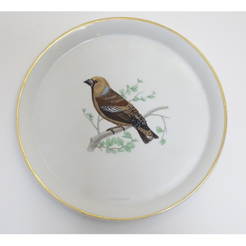 131 - A French L Lourioux Le Faune plate with a gilt rim decorated with a hawfinch bird on a branch. Marke... 