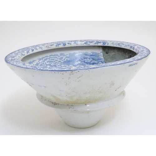 136 - A Victorian water closet bowl / pan with blue and white transfer decoration depicting figures in a c... 