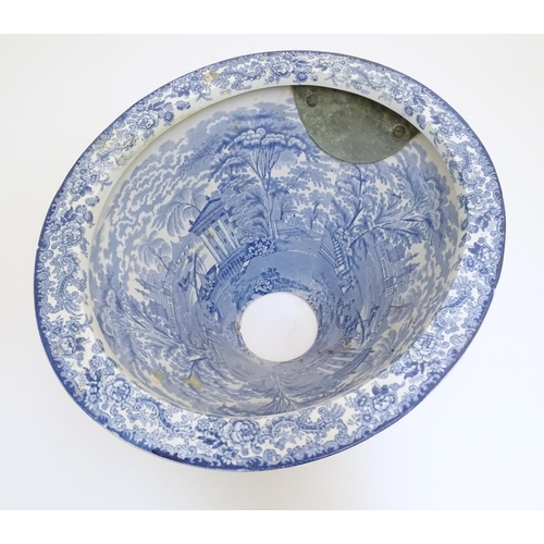 136 - A Victorian water closet bowl / pan with blue and white transfer decoration depicting figures in a c... 