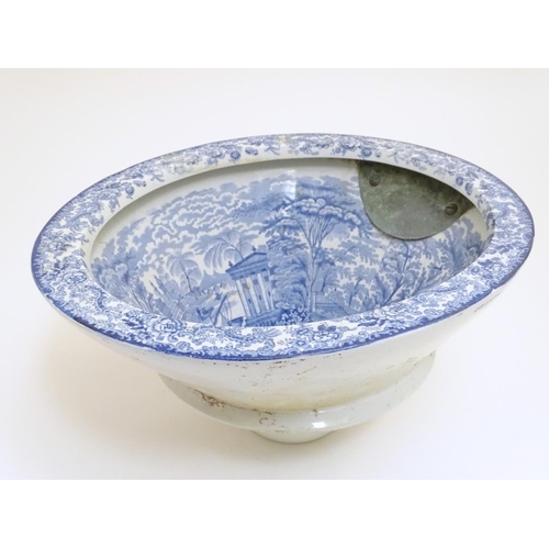 136 - A Victorian water closet bowl / pan with blue and white transfer decoration depicting figures in a c... 