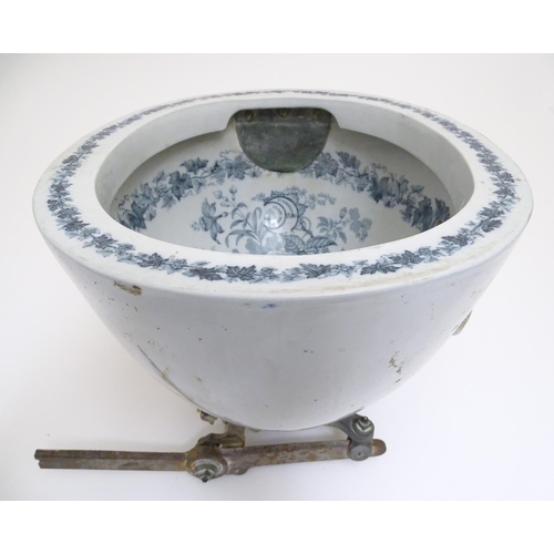 140 - A Victorian water closet bowl / pan with blue and white transfer decoration depicting floral motifs ... 