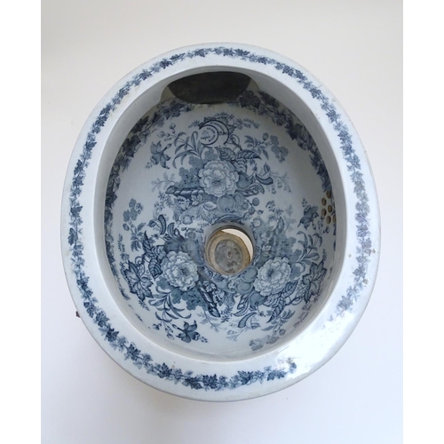 140 - A Victorian water closet bowl / pan with blue and white transfer decoration depicting floral motifs ... 