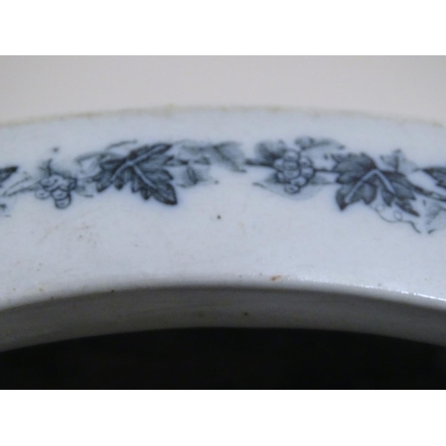 140 - A Victorian water closet bowl / pan with blue and white transfer decoration depicting floral motifs ... 