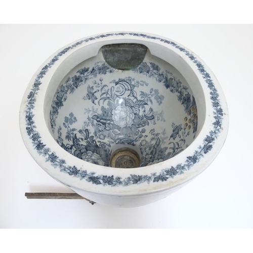 140 - A Victorian water closet bowl / pan with blue and white transfer decoration depicting floral motifs ... 