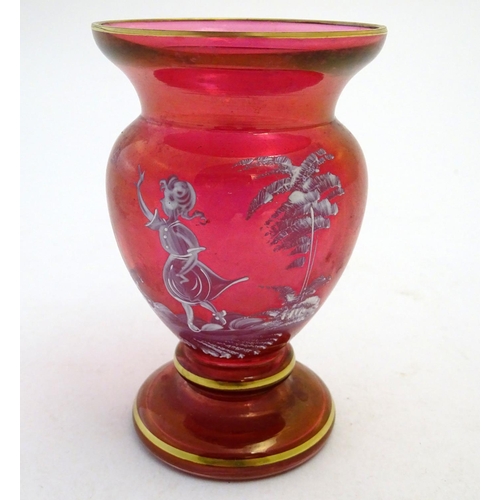 146 - An early 20thC Mary Gregory cranberry glass vase, decorated with an enamelled vignette of girl in wo... 