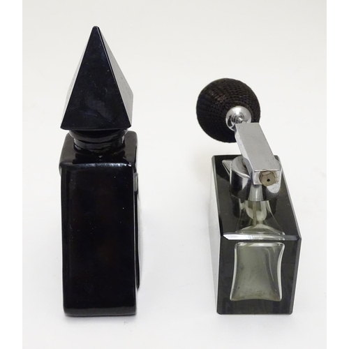 148 - Two Art Deco glass scent bottles, one black glass formed as a pyramid, the other smoked glass with a... 