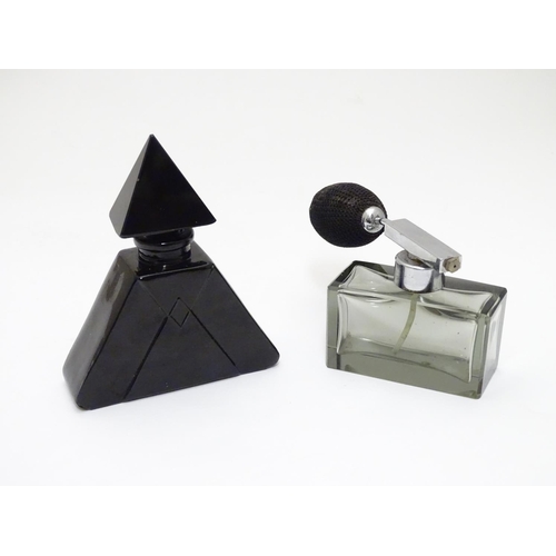 148 - Two Art Deco glass scent bottles, one black glass formed as a pyramid, the other smoked glass with a... 