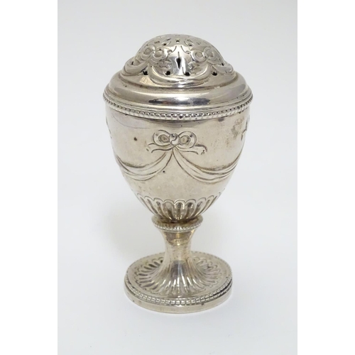 190 - A Geo IV silver pepperette of urn form. Hallmarked London 1823 maker J.A.  3 1/2