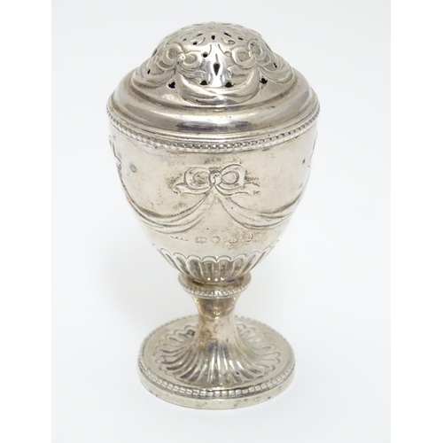 190 - A Geo IV silver pepperette of urn form. Hallmarked London 1823 maker J.A.  3 1/2