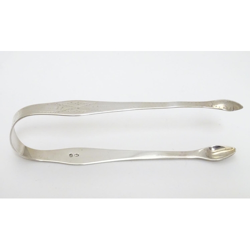 201 - Geo III silver sugar tongs with bright cut decoration. Maker Hester Bateman. Late 18thC . Approx 5 1... 