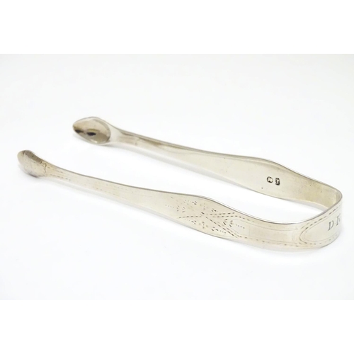 201 - Geo III silver sugar tongs with bright cut decoration. Maker Hester Bateman. Late 18thC . Approx 5 1... 