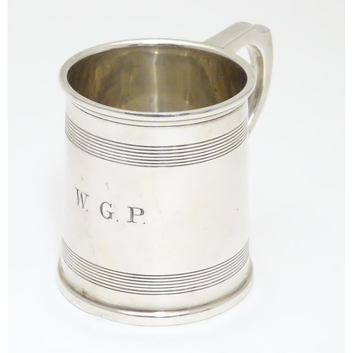 210 - A silver Christening mug  with banded detail. Hallmarked Birmingham 1929 maker A & J Zimmerman Ltd. ... 