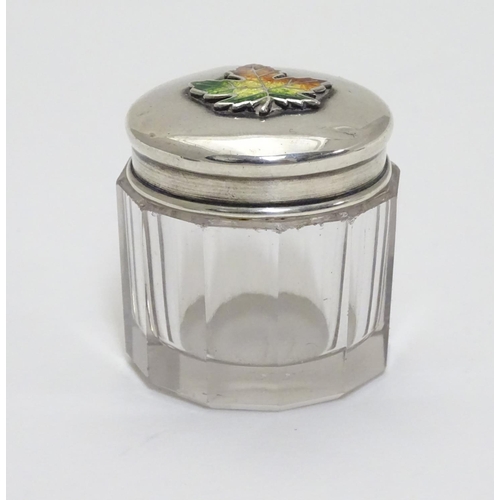 226 - A glass toilet pot with Sterling silver lid having maple leaf decoration with enamel detail. Maker M... 