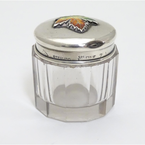 226 - A glass toilet pot with Sterling silver lid having maple leaf decoration with enamel detail. Maker M... 