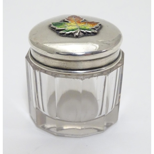 226 - A glass toilet pot with Sterling silver lid having maple leaf decoration with enamel detail. Maker M... 