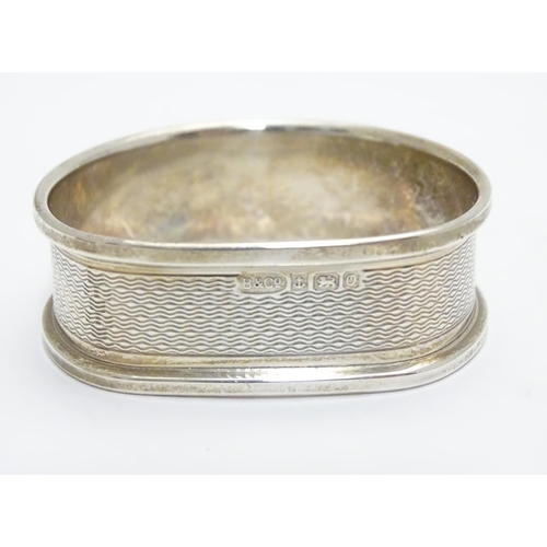 277 - A silver napkin ring with engine turned decoration hallmarked Birmingham 1988 maker B& Co.