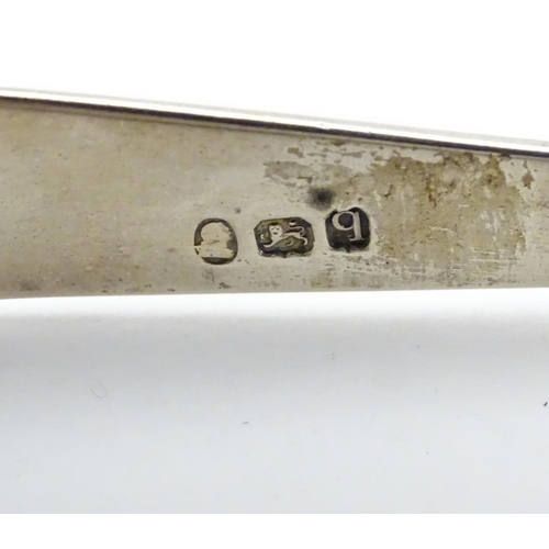 297 - Geo III silver sugar tongs with bright cut decoration hallmarked London 1791 maker GW. 5 1/4