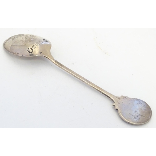 298 - A silver spoon the handle surmounted by image of a golfer and the bowl engraved St. Melyd Golf Club.... 