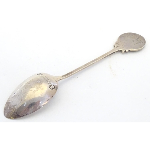 298 - A silver spoon the handle surmounted by image of a golfer and the bowl engraved St. Melyd Golf Club.... 