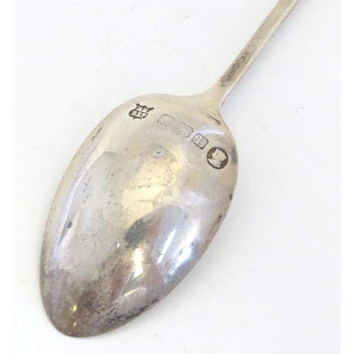 298 - A silver spoon the handle surmounted by image of a golfer and the bowl engraved St. Melyd Golf Club.... 