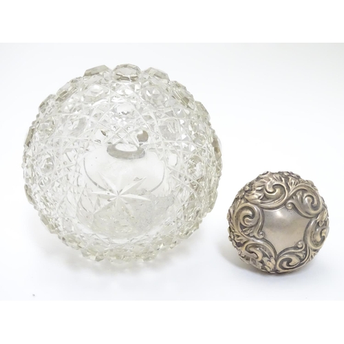 314 - A cut glass scent bottle of spherical form with silver mounts and top hallmarked Birmingham 1899 mak... 