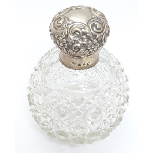 314 - A cut glass scent bottle of spherical form with silver mounts and top hallmarked Birmingham 1899 mak... 