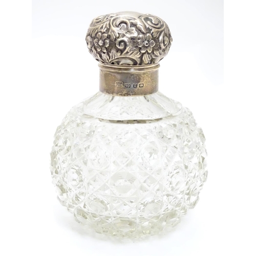 314 - A cut glass scent bottle of spherical form with silver mounts and top hallmarked Birmingham 1899 mak... 