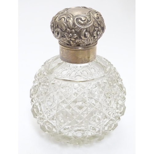 314 - A cut glass scent bottle of spherical form with silver mounts and top hallmarked Birmingham 1899 mak... 