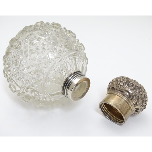 314 - A cut glass scent bottle of spherical form with silver mounts and top hallmarked Birmingham 1899 mak... 