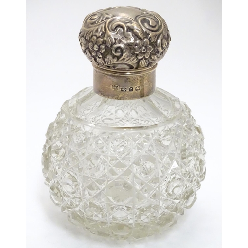 314 - A cut glass scent bottle of spherical form with silver mounts and top hallmarked Birmingham 1899 mak... 