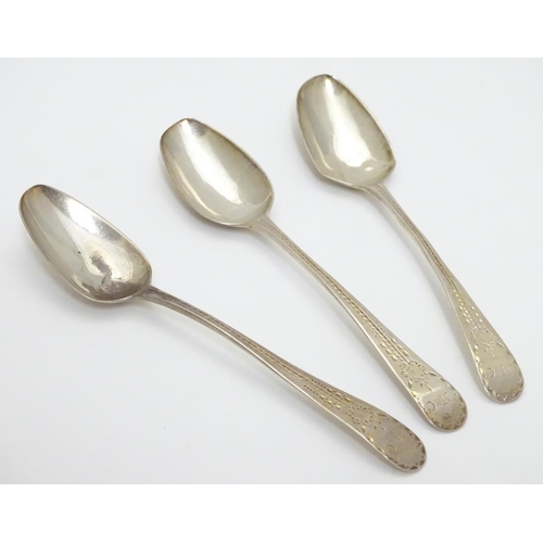 321 - A set of three William IV silver teaspoons with bright cut decoration to handles. Hallmarked 1832 ma... 