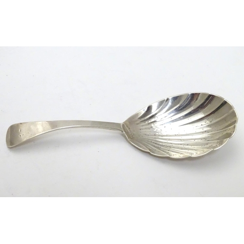 330 - A 19thC silver shell formed caddy spoon. Hallmarked London 1820 maker Thomas Wilkes
Barker. 4