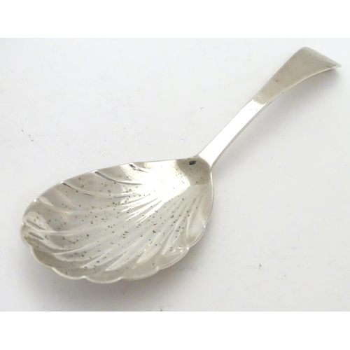 330 - A 19thC silver shell formed caddy spoon. Hallmarked London 1820 maker Thomas Wilkes
Barker. 4