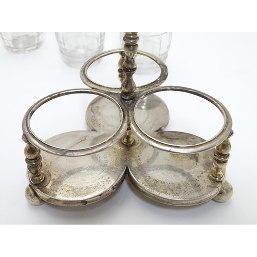 332 - A Victorian silver cruet stand with three glass bottles of barrel form with silver mounts. Hallmarke... 