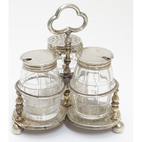 332 - A Victorian silver cruet stand with three glass bottles of barrel form with silver mounts. Hallmarke... 