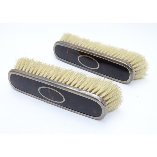 334 - A pair of silver and tortoiseshell mounted clothes brushes. Hallmarked Birmingham 1922 maker Levi & ... 