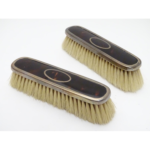 334 - A pair of silver and tortoiseshell mounted clothes brushes. Hallmarked Birmingham 1922 maker Levi & ... 