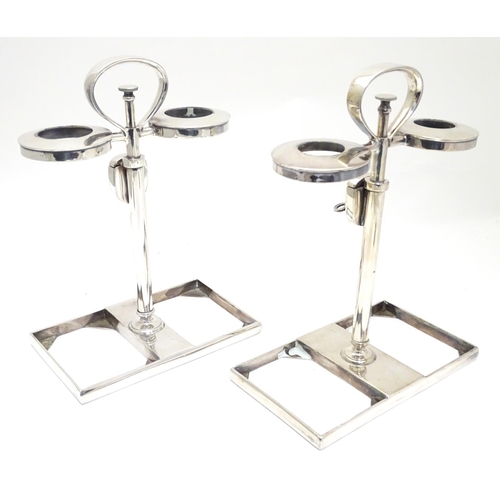 420 - A matched pair of silver plate decanter stands / tantalus with locking mechanism to central column. ... 