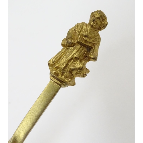 429 - A cased set of four gilded serving spoons surmounted by a religious figure. Each approx. 8