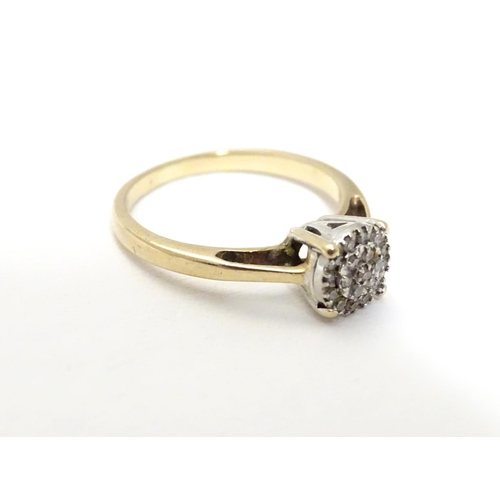 454 - A 9ct gold ring set with a profusion of diamonds. Ring size approx. I