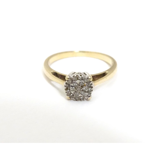 454 - A 9ct gold ring set with a profusion of diamonds. Ring size approx. I