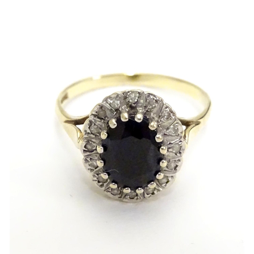 455 - A 9ct gold ring set with facet cut blue spinel bordered by diamonds. Ring size approx N.