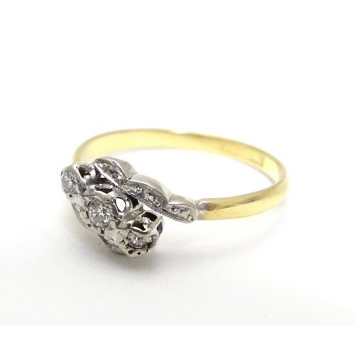 457 - An 18ct gold ring set with trio of platinum set diamonds to top. Ring size approx M 1/2