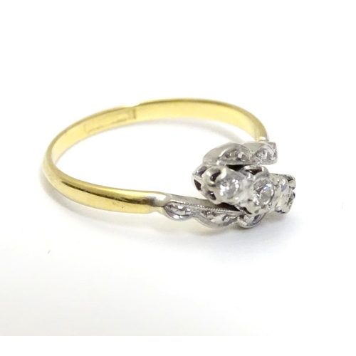 457 - An 18ct gold ring set with trio of platinum set diamonds to top. Ring size approx M 1/2