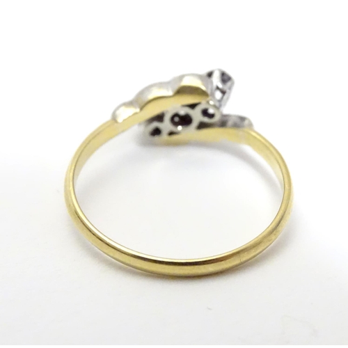 457 - An 18ct gold ring set with trio of platinum set diamonds to top. Ring size approx M 1/2