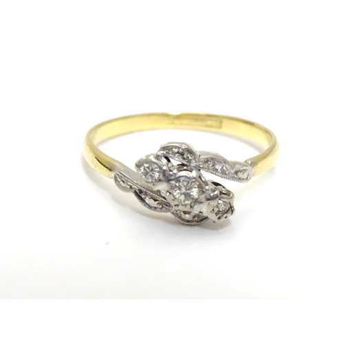 457 - An 18ct gold ring set with trio of platinum set diamonds to top. Ring size approx M 1/2